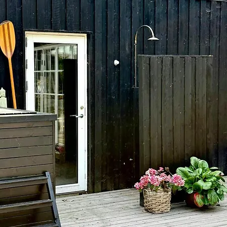 Wooden House With Animals And Kayaks Near *